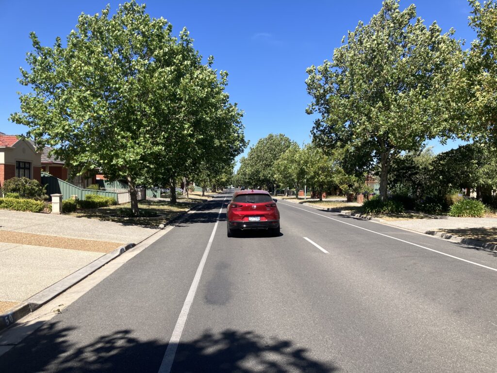 Red learner driver car on a Ballarat street during a driving lesson