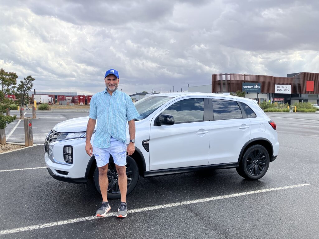 Driving instructor Tim standing beside learner driver vehicle in Ballarat