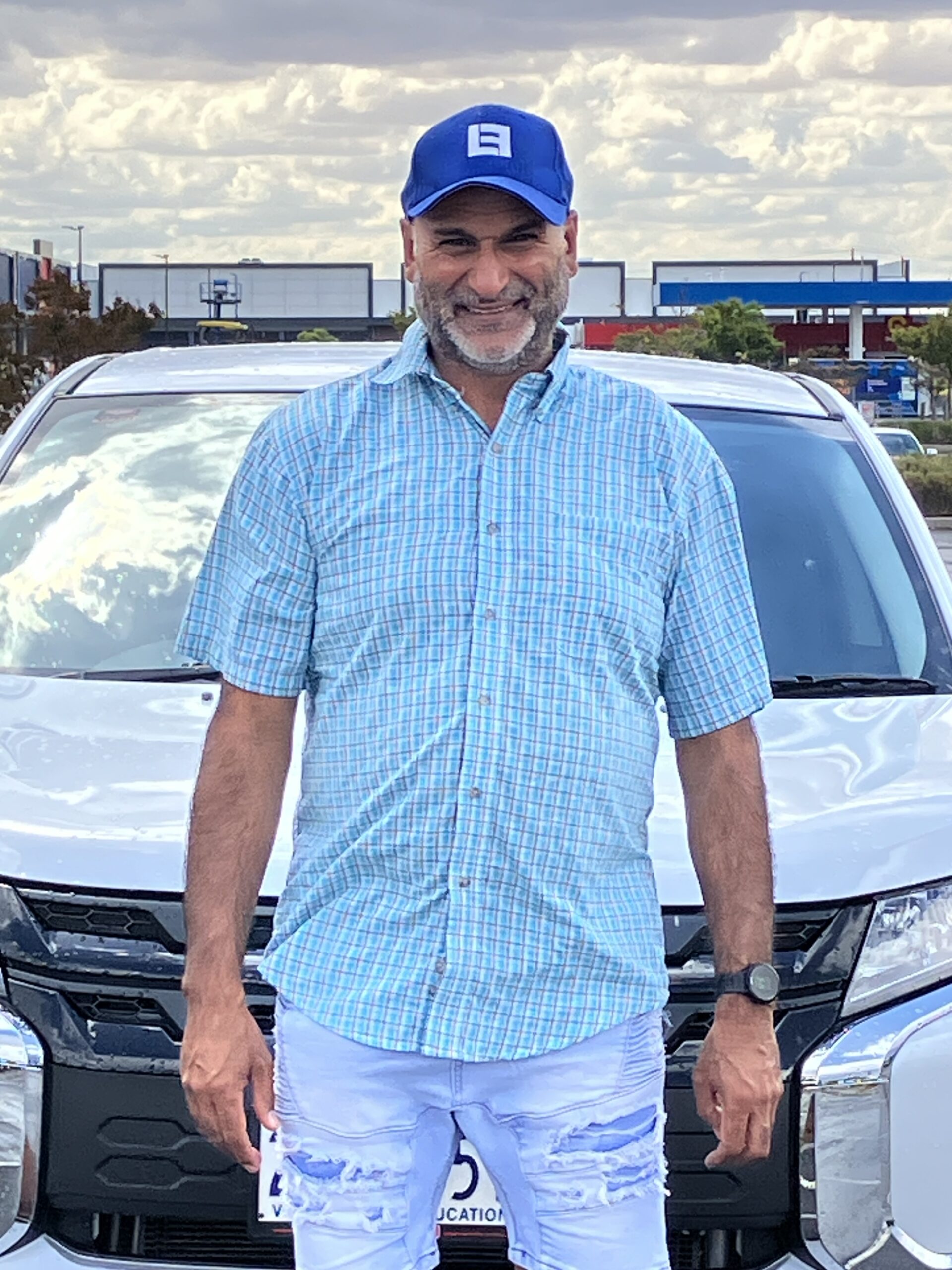 Tim Dhillon, driving instructor in Ballarat, standing with his lesson vehicle