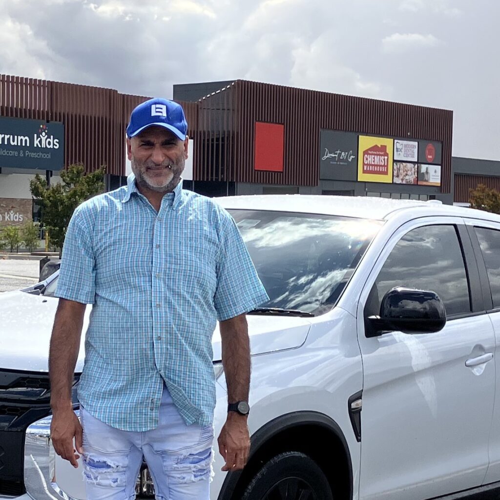 Tim close crop Tim Dhillon, local Ballarat driving instructor with his lesson vehicle