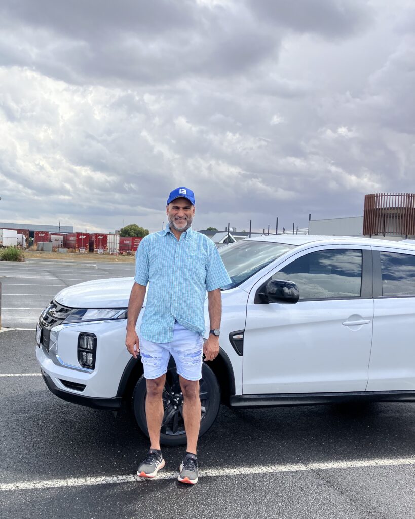 Tim Dhillon driving instructor Tim Dhillon, Ballarat driving instructor standing with his lesson vehicle